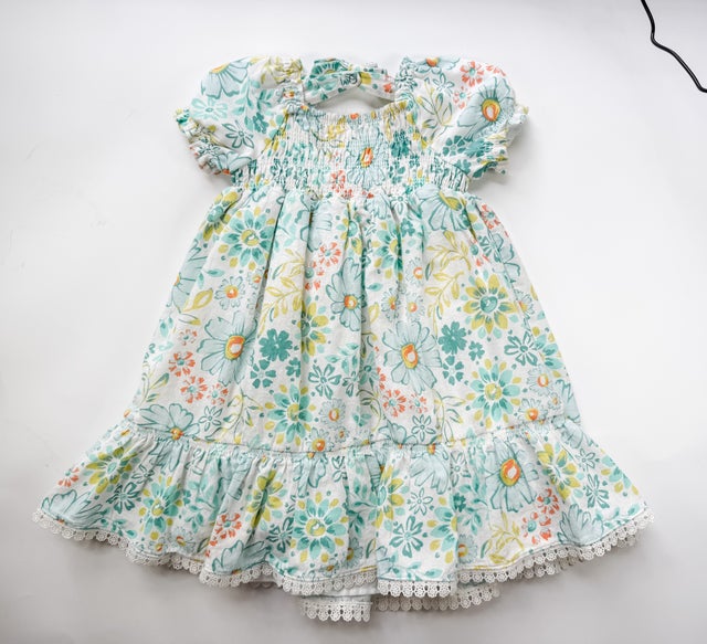 blue dress 5t girlhood blue short sleeve dress with positive affirmation pennants. Peter Pan collar, full flowy skirt & keyhole tie at back of neck. Size 4/5T
